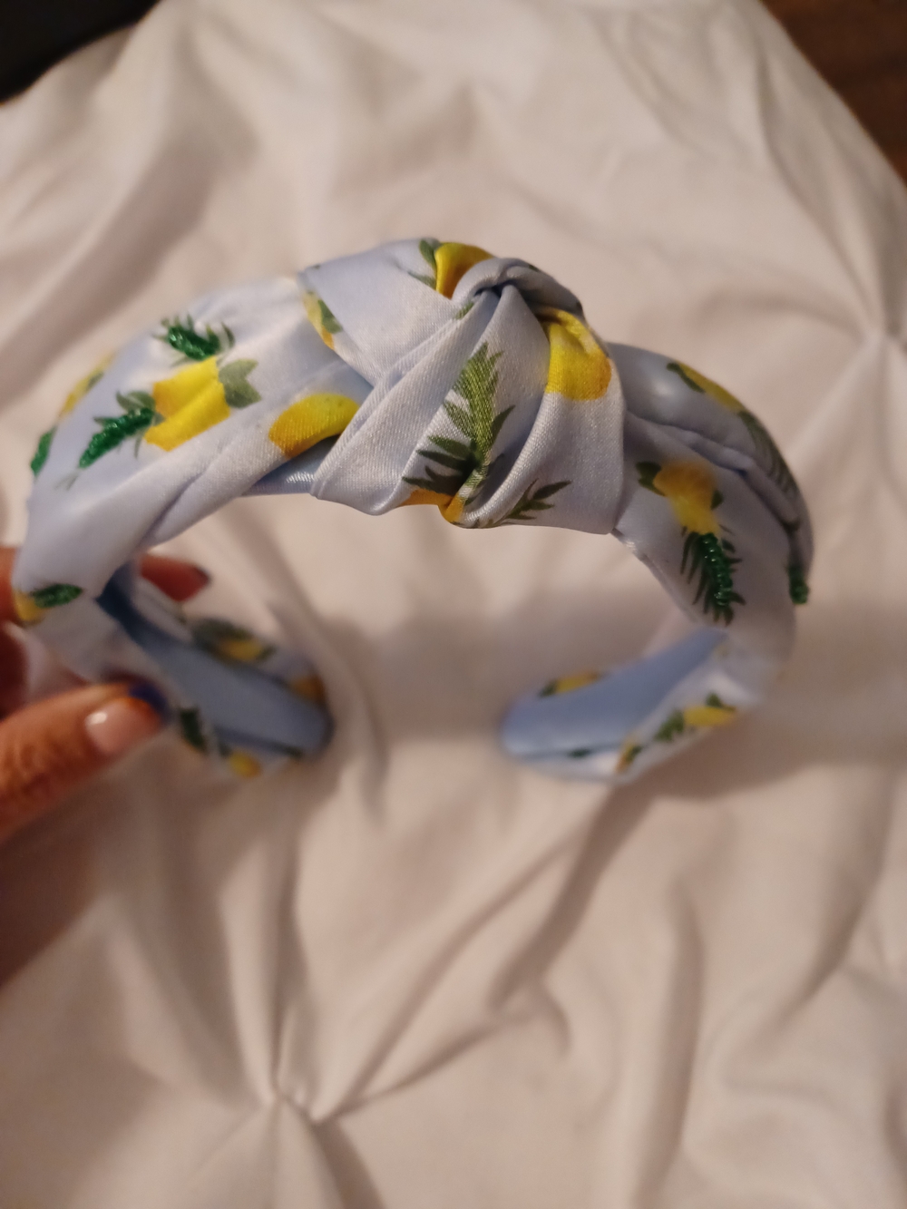 light blue knotted headband featuring a yellow and green lemon print.